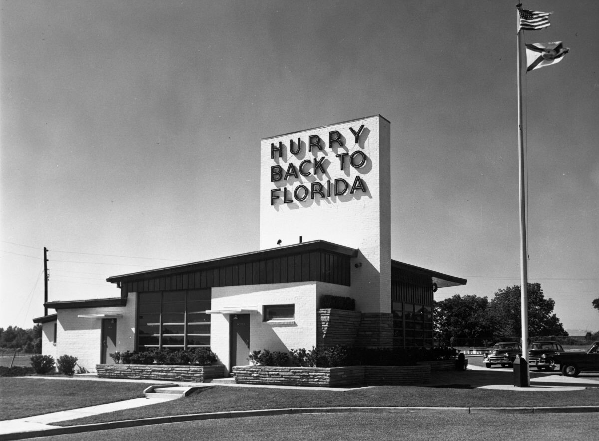 A historic mid-century welcome center with a sign stating