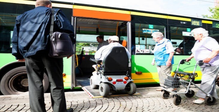 Several people boarding a bus
